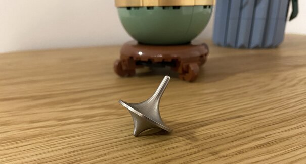 Metal top on wooden surface with lego pots in background